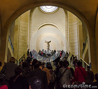 Trippers admire Winged Victory of Samothrace, also called the Ni