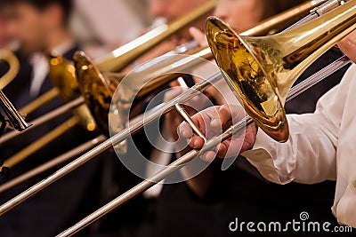 Trombones in the hands of musicians