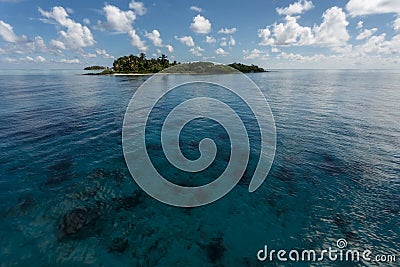 Tropical island rises above coral reef in Hol Chan Marine Reserve Belize