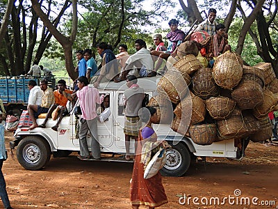 A truck crowded with people and baskets