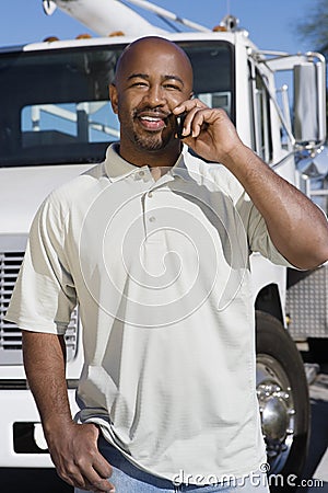 Truck Driver On Phone In Front Of A Truck