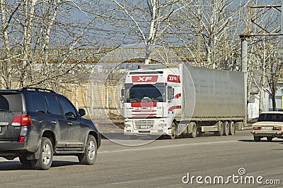 Truck is going down dirty and dusty city road