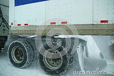 Truck tires spinning on highway during snowstorm
