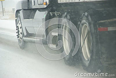 Truck tires spinning on highway during snowstorm