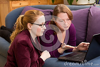 Two annoyed women with computer