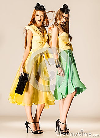 Two beautiful girls dressed in summer dresses