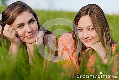 Two Beautiful happy smiling young women in grass