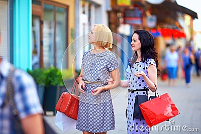 Two beautiful women walking the city street