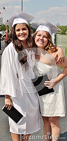Two beautiful young girls on high school graduation day
