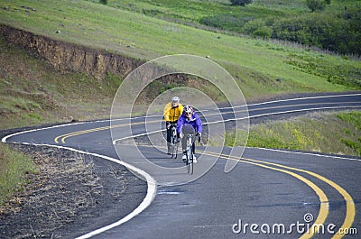 Two bicycle riders on rural road