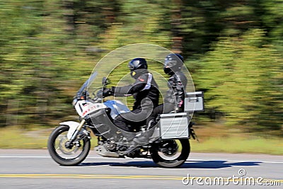 Two Bikers Riding a Motorcycle, motion blur