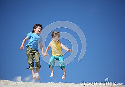 Two Boys Jump On Sand Royalty Free Stock P