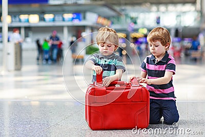 Two brother boys going on vacations trip at airport