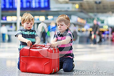 Two brother boys going on vacations trip at airport