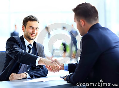 Two business colleagues shaking hands during
