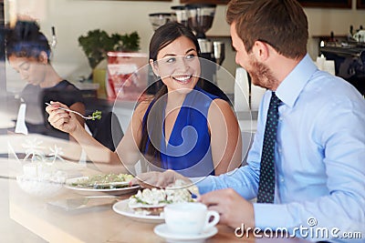 Two Businesspeople Meeting For Lunch In Coffee Shop