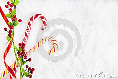 Two Candy Canes With Christmas Decoration On Snowy Background