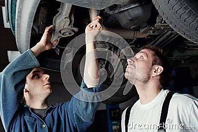 Two Car Mechanic repairing car