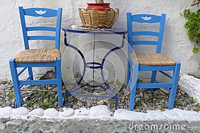 Two chairs outside a Greek restaurant