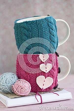 Two cups in blue and pink sweater with hearts