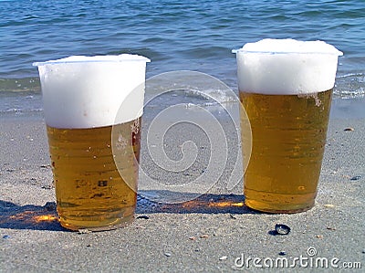 Two disposable plastic glasses with beer.