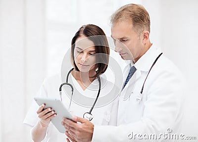 Two doctors looking at tablet pc