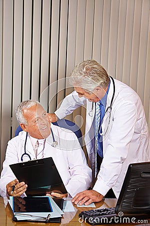 Two doctors talking in hospital office