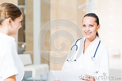 Two doctors talking in the lobby of the hospital