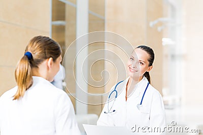 Two doctors talking in the lobby of the hospital