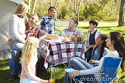 Two Families Enjoying Camping Holiday In Countryside