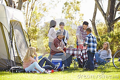 Two Families Enjoying Camping Holiday In Countryside