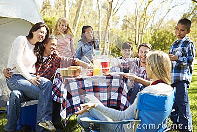 Two Families Enjoying Camping Holiday In Countryside