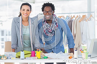 Two fashion designers smiling