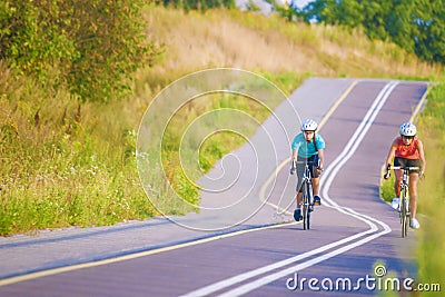 Two female caucasian sportswoman riding sports bikes