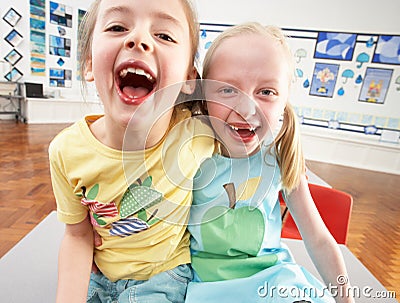 Two Female Primary Schoolchildren In Classroom