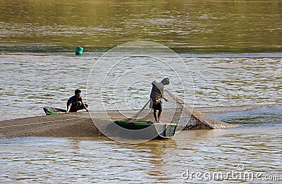 Two fisherman catching fish by net