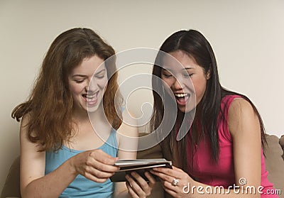 Two friends laughing at photographs