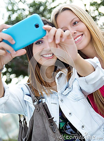 Two friends taking photos with a smartphone