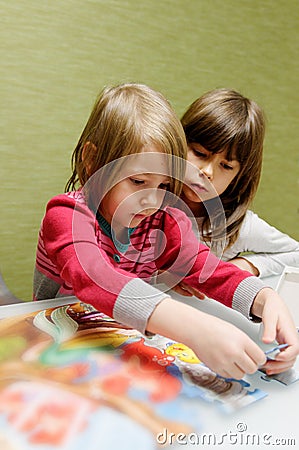 Two girls doing puzzle