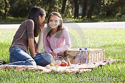 Two girls having picnic in park