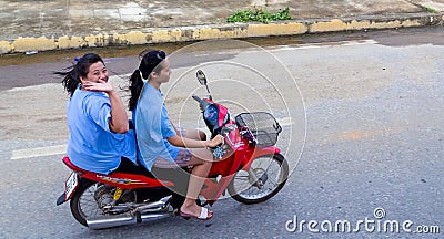 Two girls on a motorcycle in Thailand