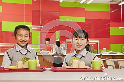 Two girls sitting in school cafeteria