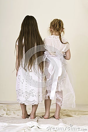 Two girls in white dresses are back