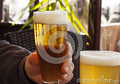 Two glasses of beer in bar.