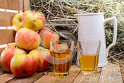 Two glasses of cider with some apples