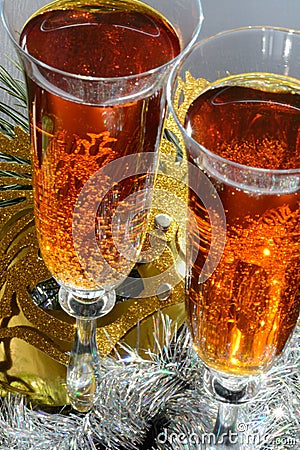 Two glasses in festive tinsel tinsel and mask