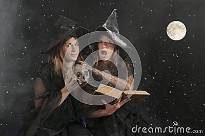 Two halloween witches on dark background