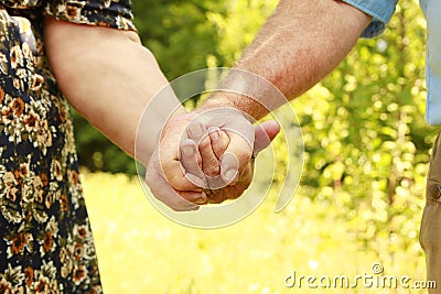 Two hands of an elderly couple