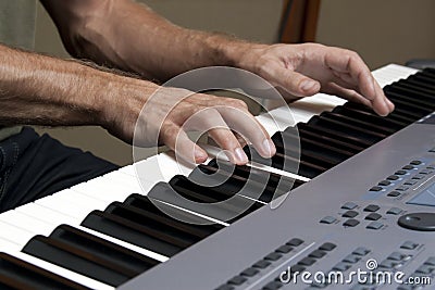 Two hands and music keyboards