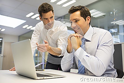 Two handsome businessmen working together on a project in the of